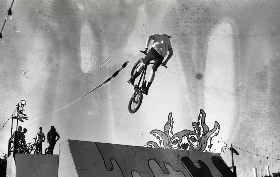 BMX biker mid-jump, with octopus image alongside the ramp.