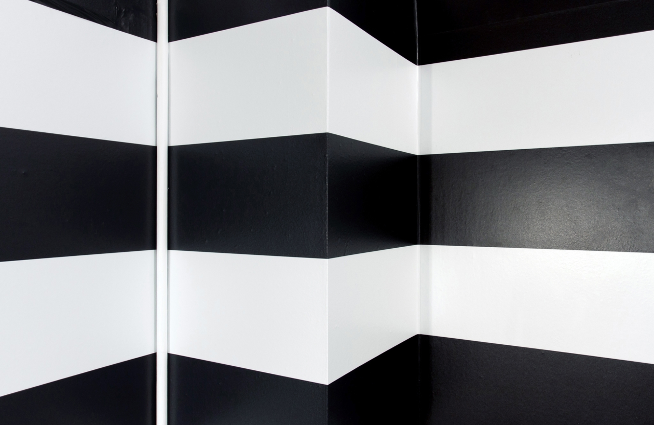 A corner that has a black-and-white striped design wrapped around it.