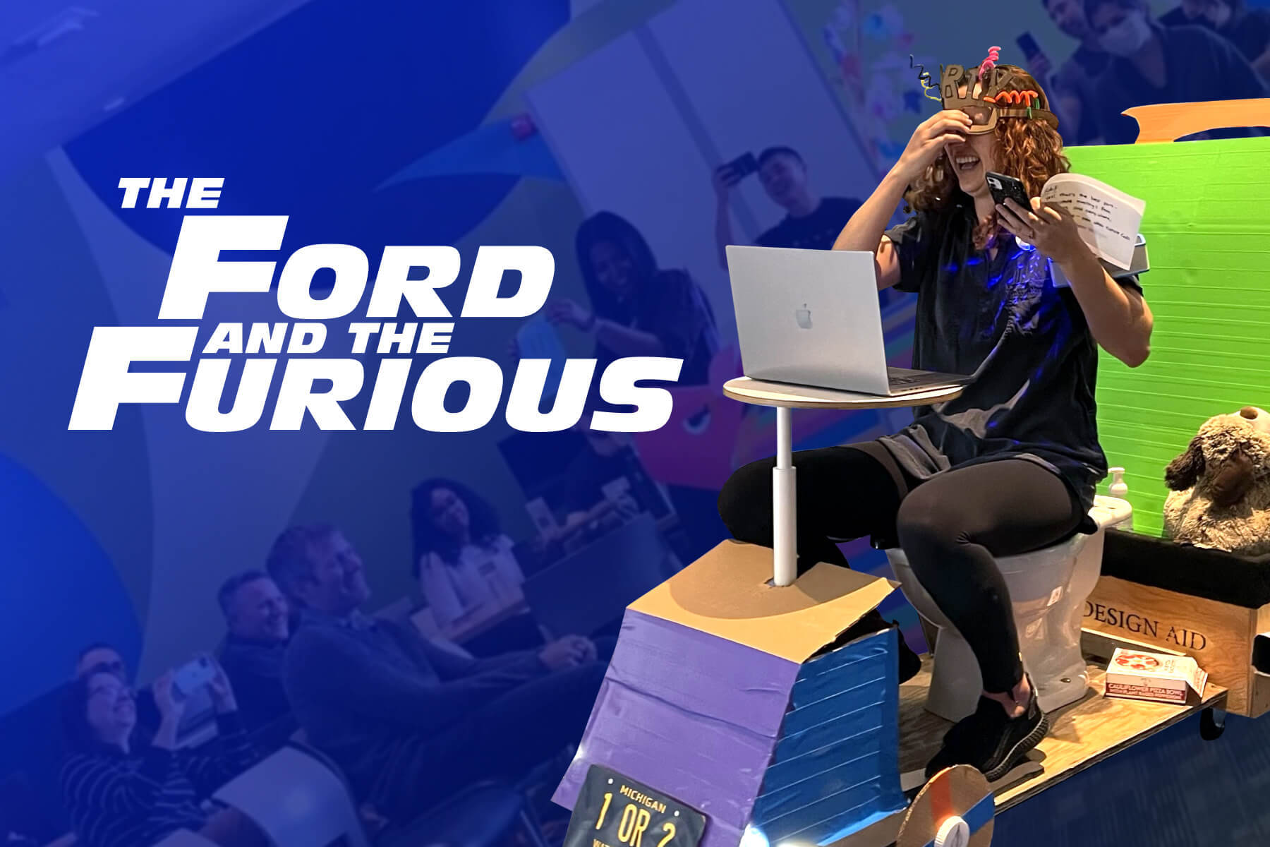 A woman sits laughing on a strange, crafted vehicle that featuers a toilet, a desk, and a stuffed animal. To her side is the text "The Ford and the Furious," and in the background are a crowd of people smiling.